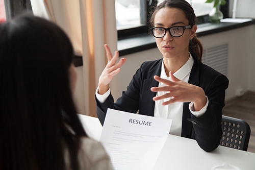 confident millennial female applicant glasses talking job interview